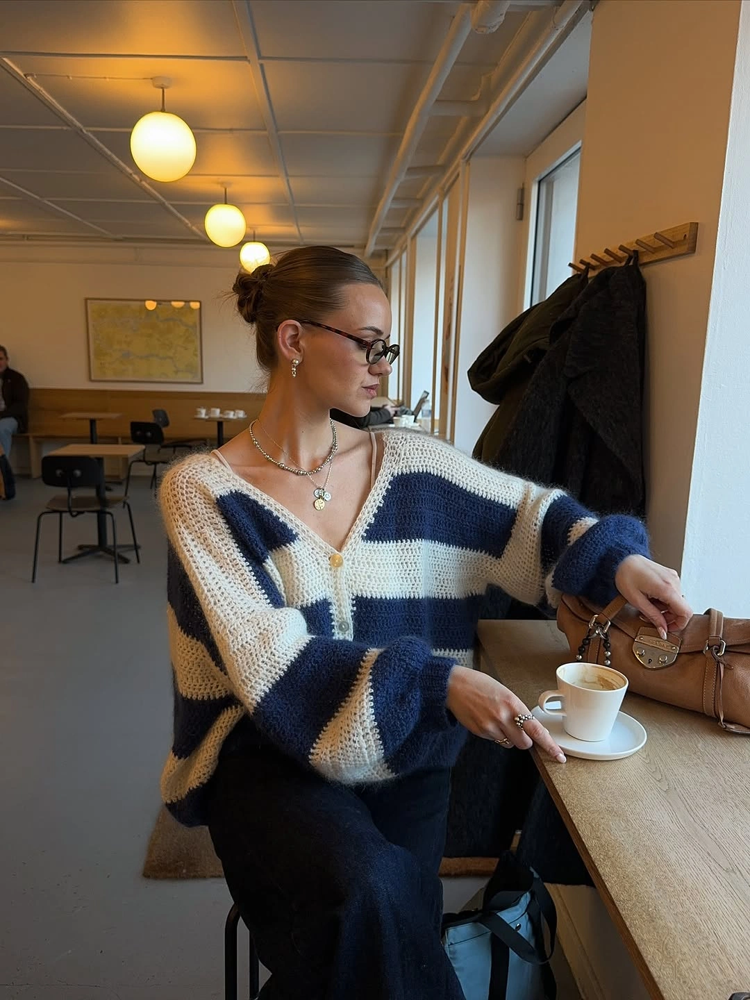 Navy and cream striped knit with tan handbag and glasses