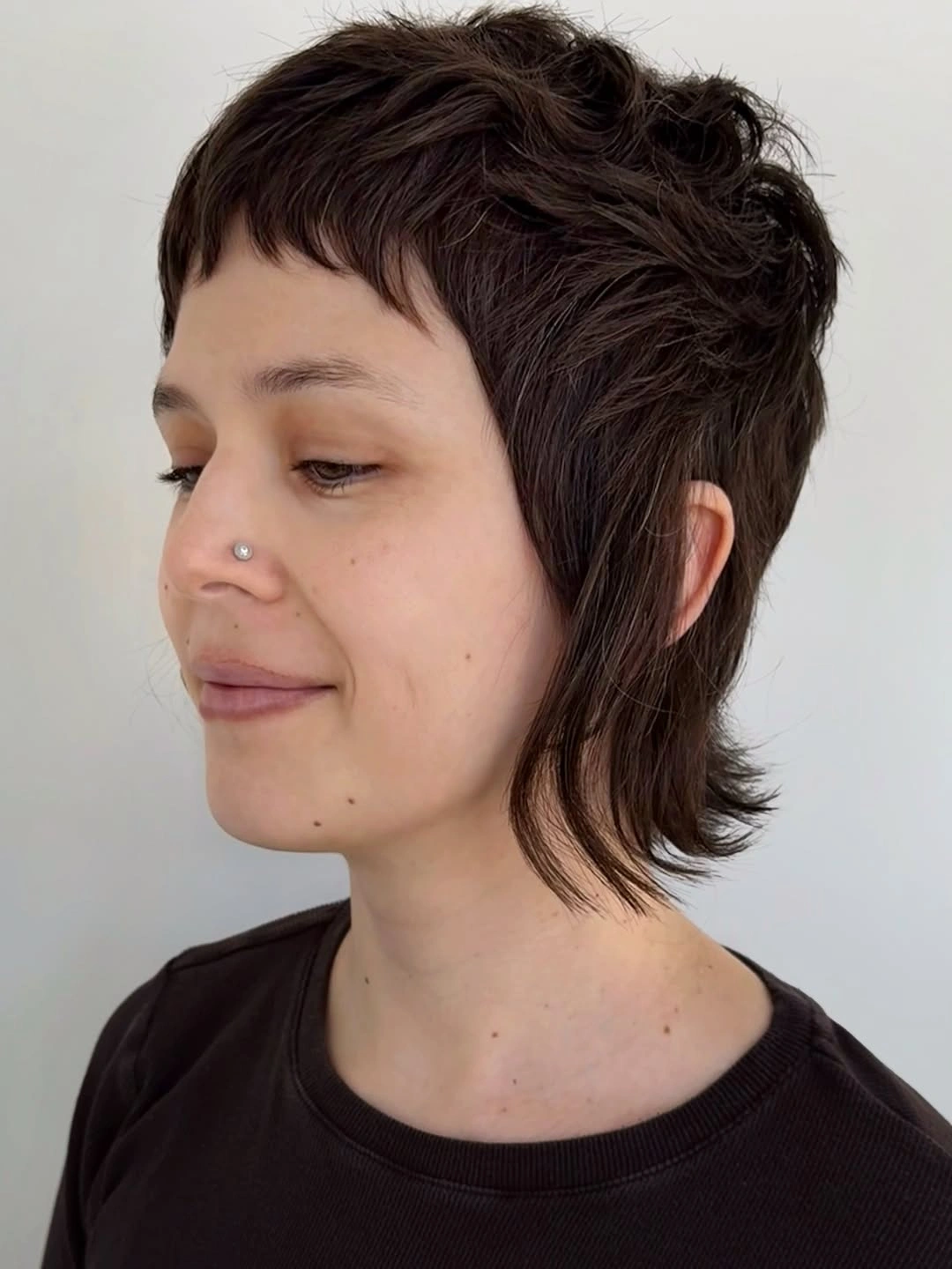 Textured dark pixie-shag with short piecey bangs