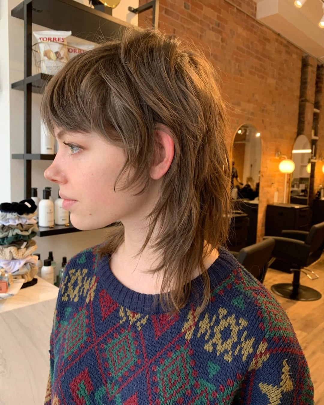 Medium brown shag haircut with short fringe and flipped nape layers
