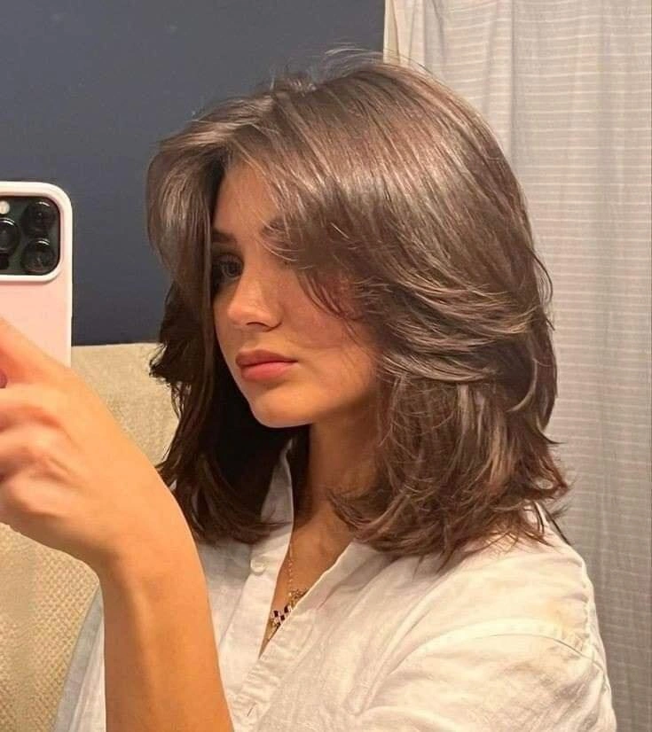 Medium brown shoulder-length layers with curtain part and flipped ends