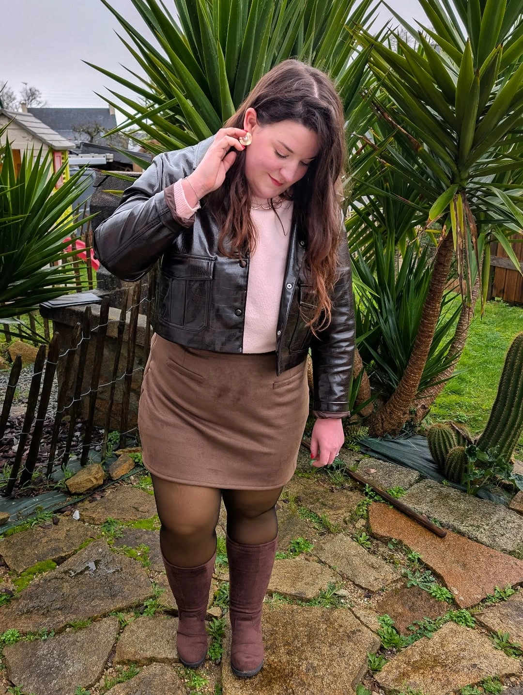 Black cropped jacket with tan skirt and mauve boots