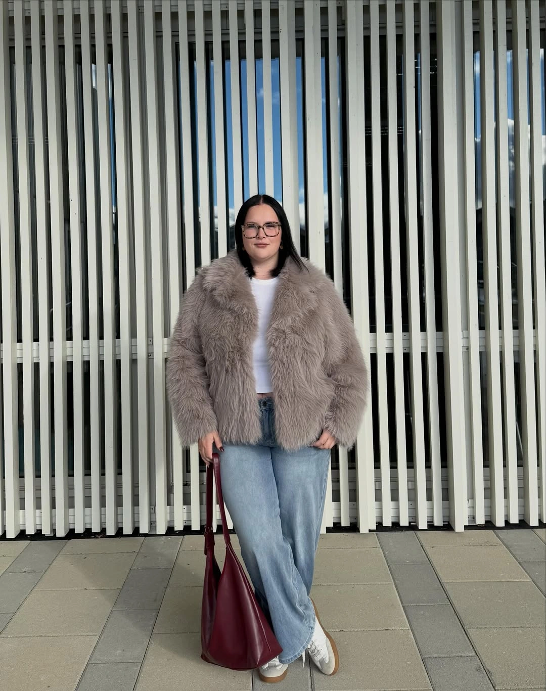 Plush gray jacket with pale jeans and burgundy tote