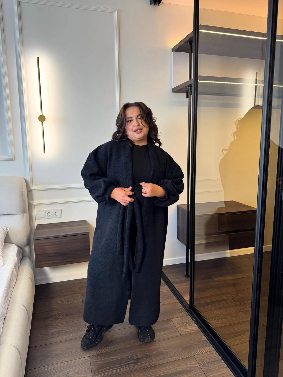 Long black textured coat over black outfit