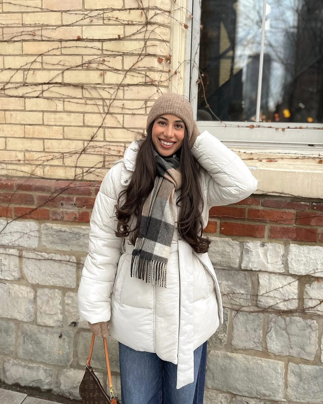 White puffer jacket with plaid scarf and wide jeans