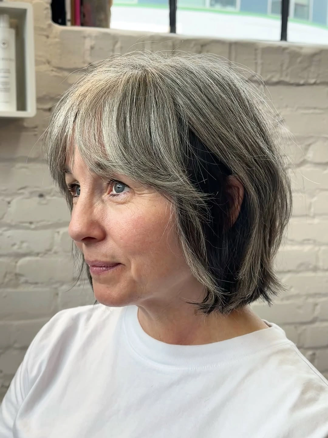 Gray chin-length bob with side-swept fringe and tucked side