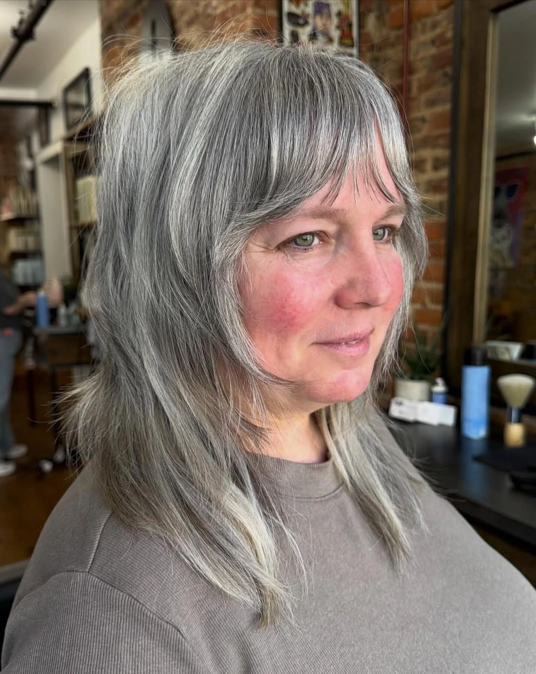 Gray shoulder-length shag with wispy fringe and feathered layers
