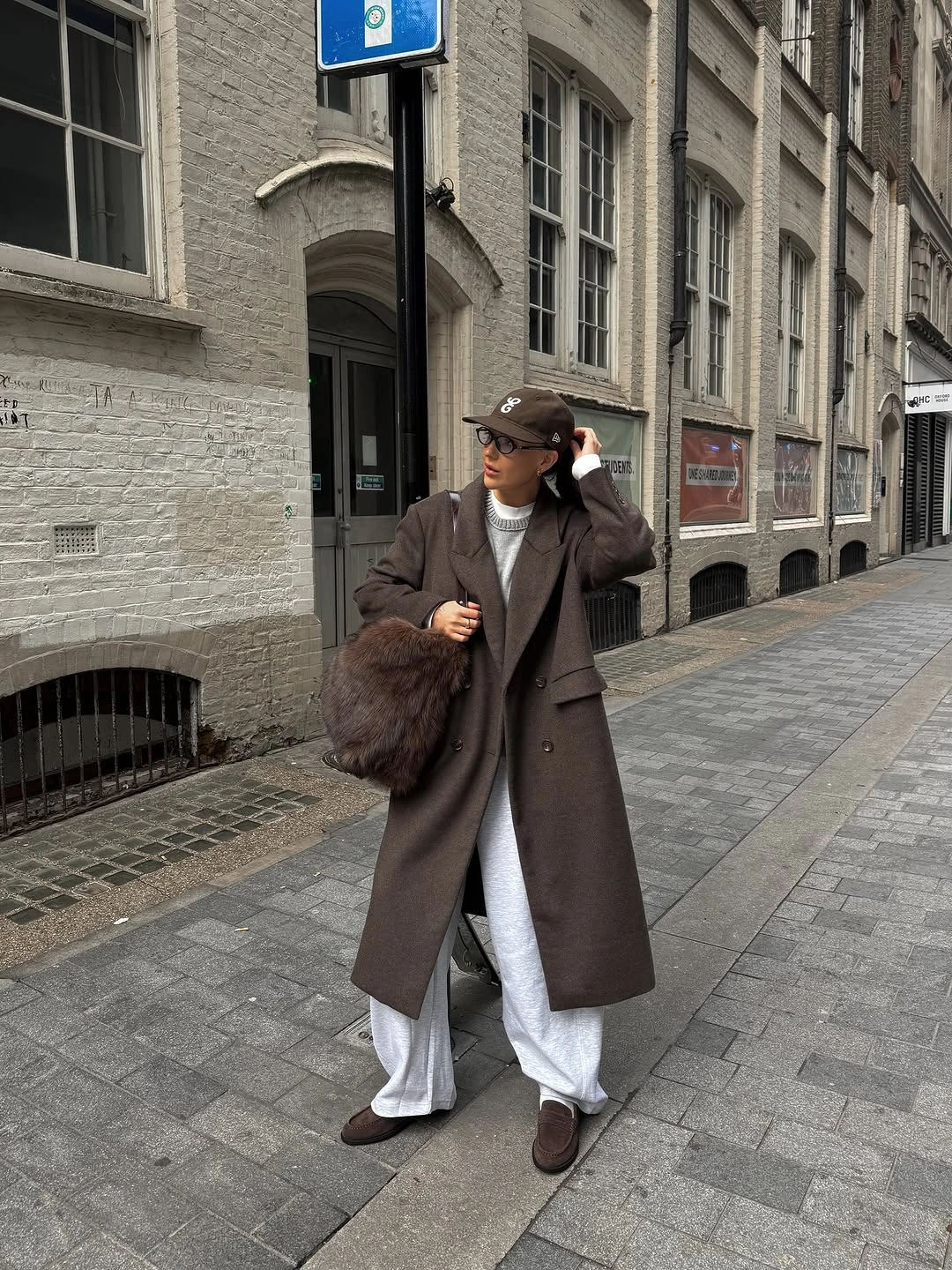 Long dark brown coat with cap and pale layers