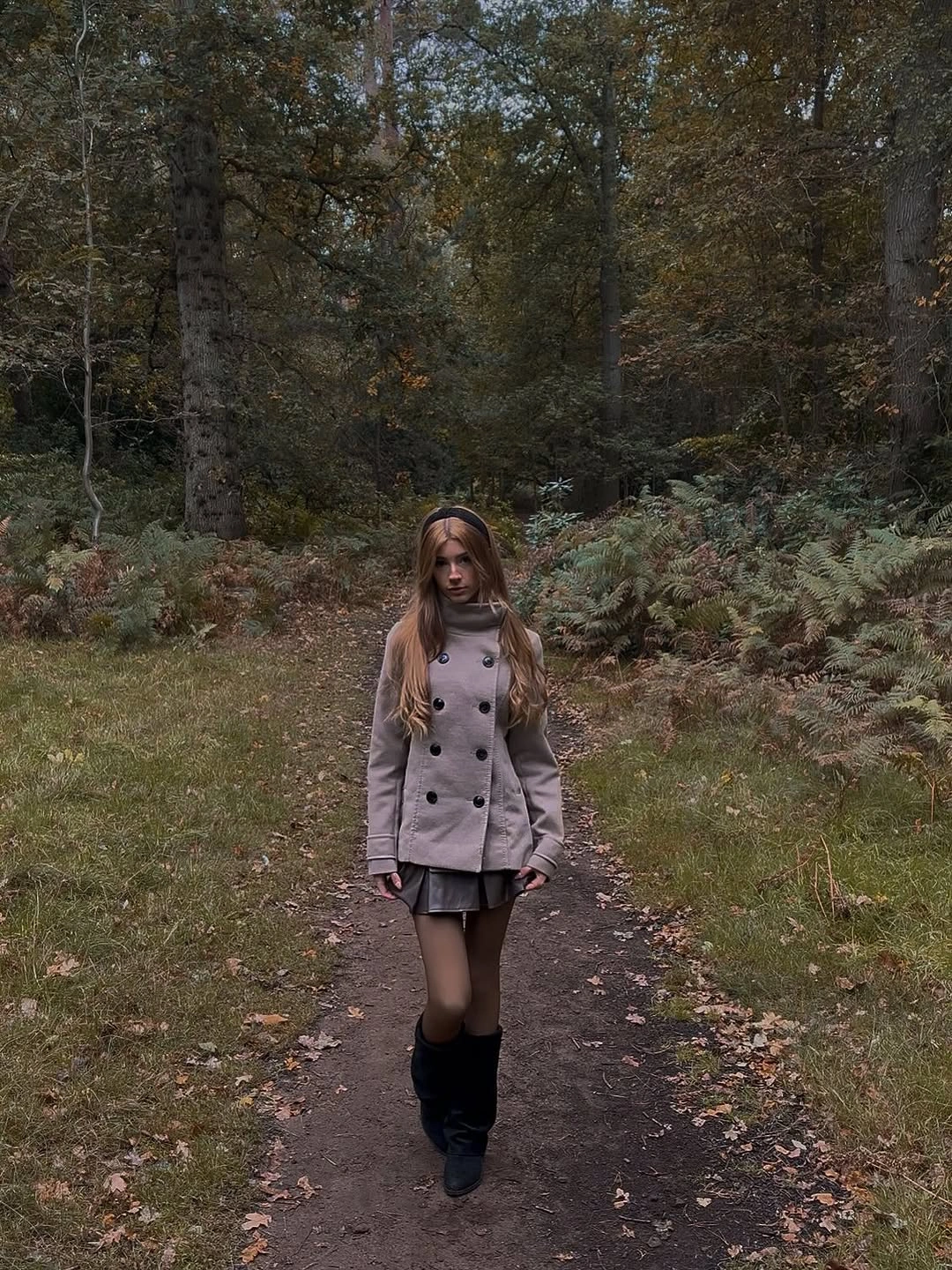 Pale double-breasted coat with dark pleated layer and boots