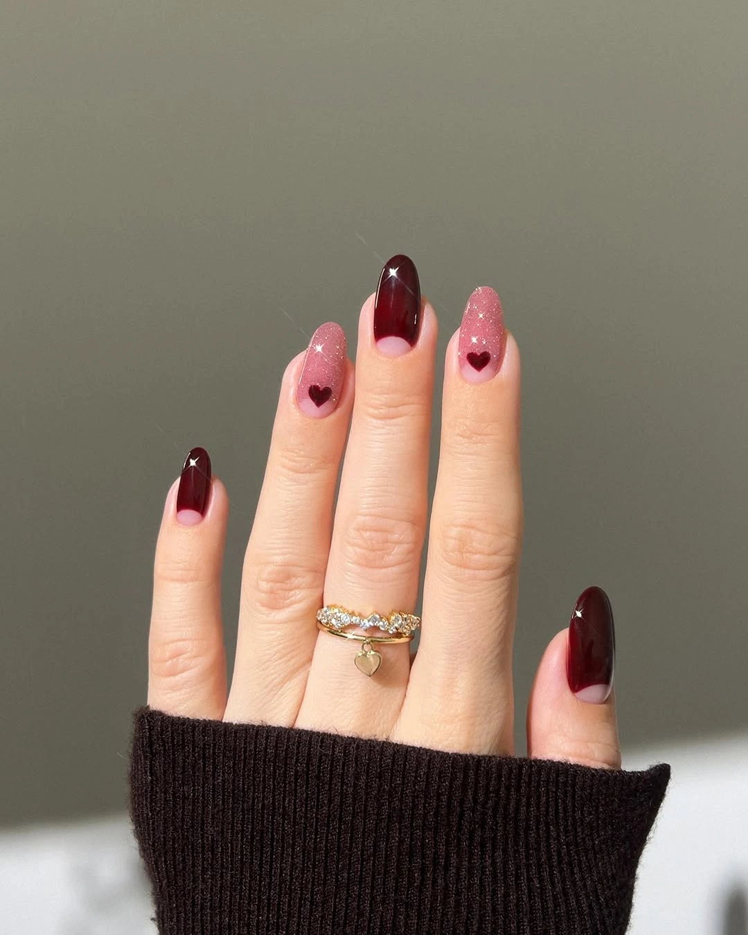 Almond burgundy and pink nails with hearts and sparkle accents
