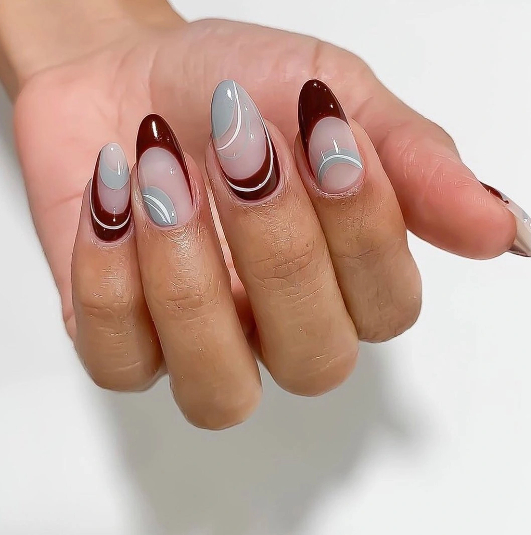 Almond nails with burgundy gray and white curved French bands