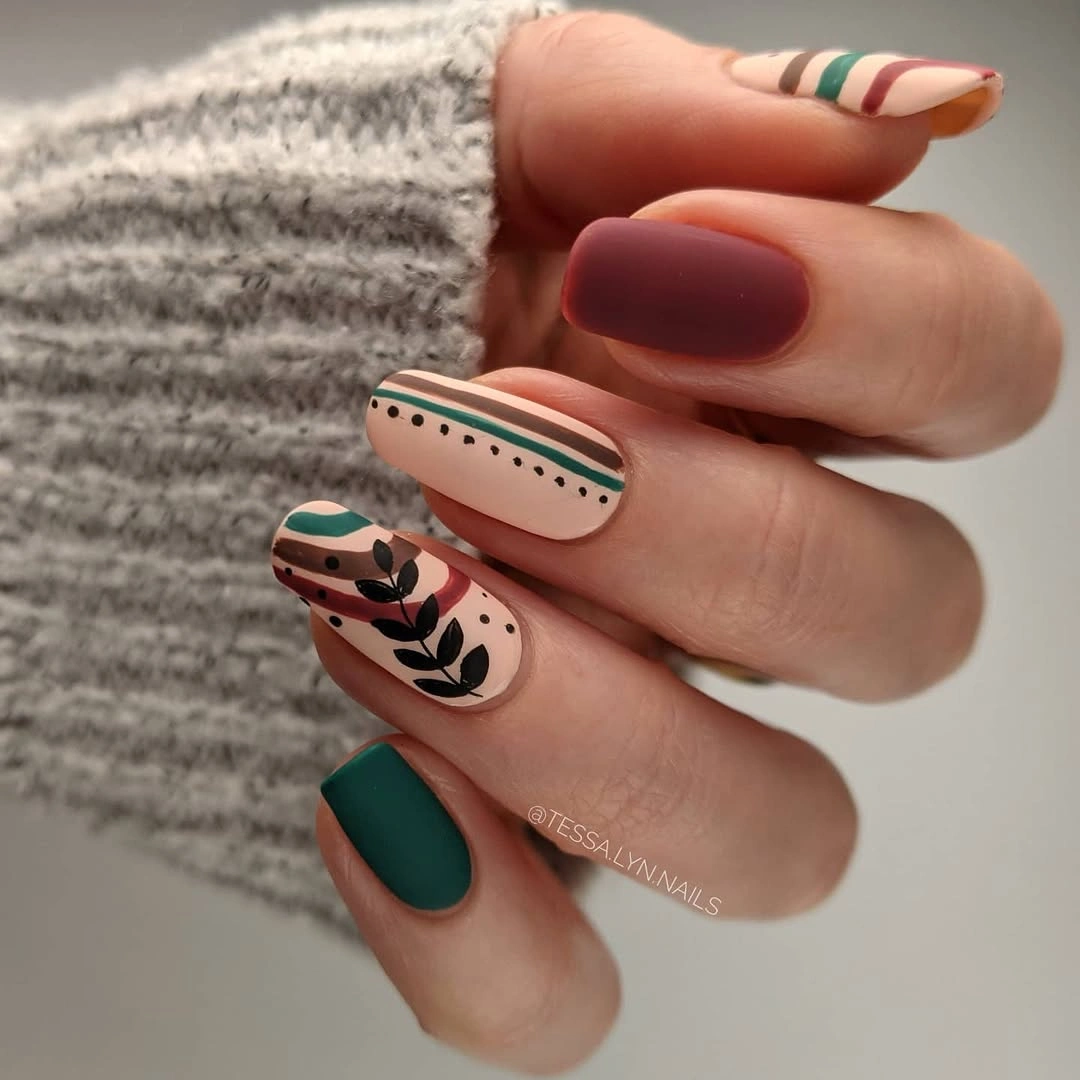 Short green burgundy and peach nails with stripes and leaves