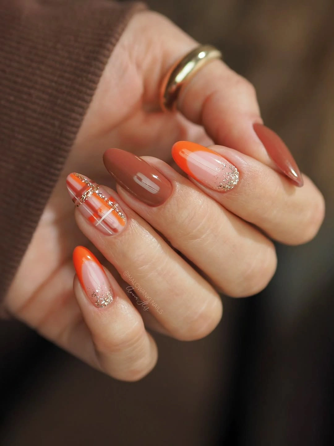 Almond nails with burnt orange caramel plaid and glitter accents