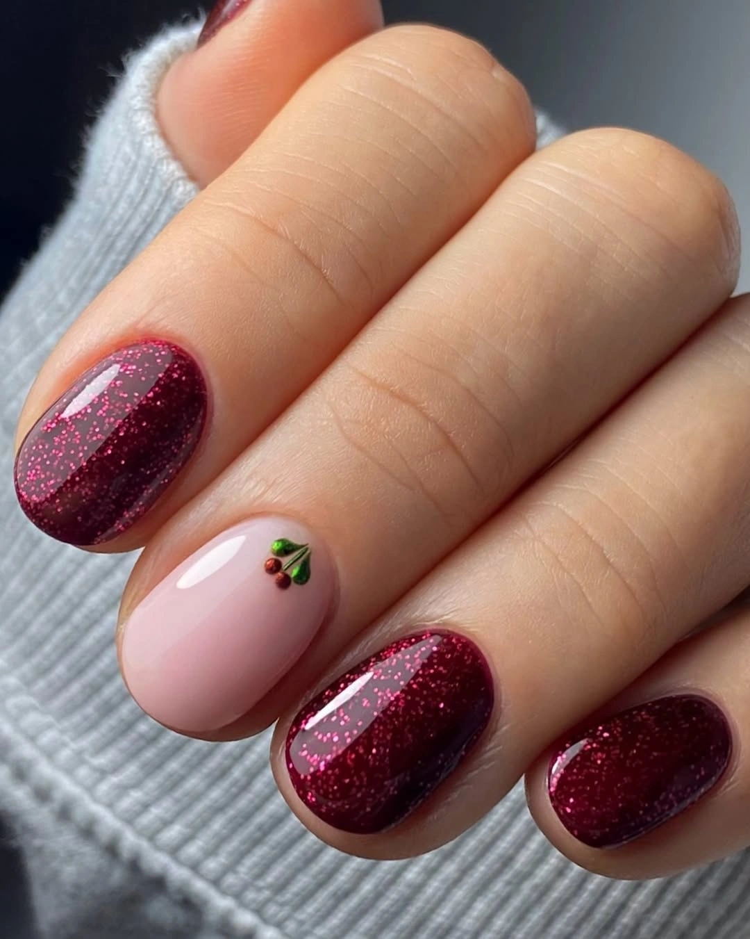 Burgundy glitter nails with pale pink leafy accent