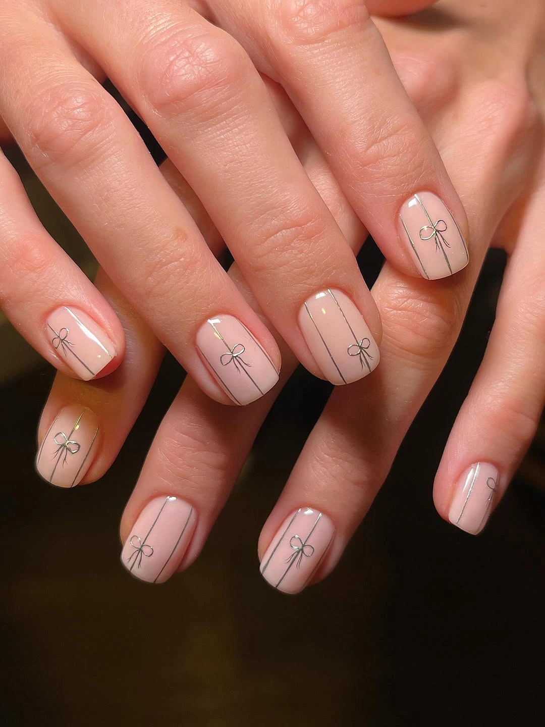 Nude short nails with fine bow line art
