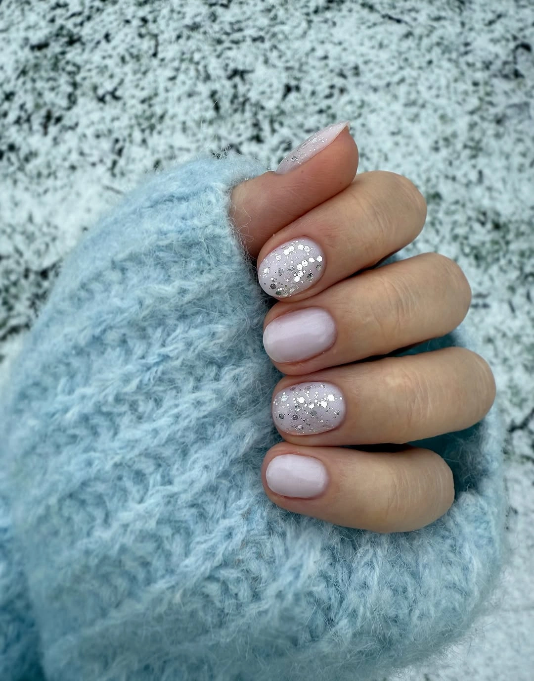 Pale pink nails with silver glitter and white dots