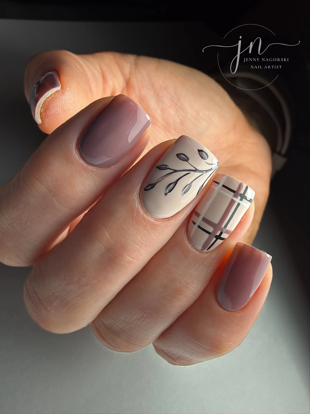 Neutral short nails with plaid and black leaf art