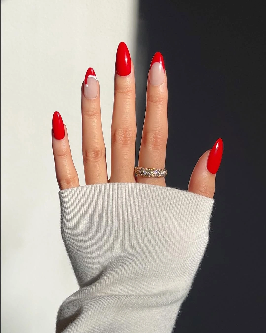 Long almond red nails with nude French tip accents