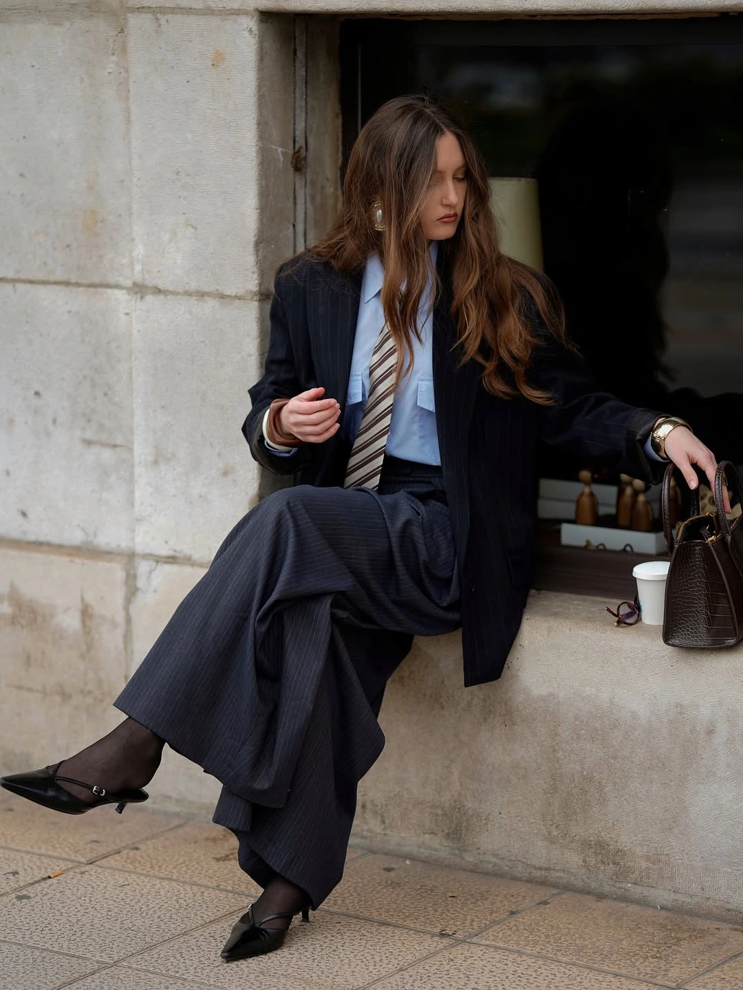 Black blazer blue shirt striped tie pinstriped trousers and slingback shoes