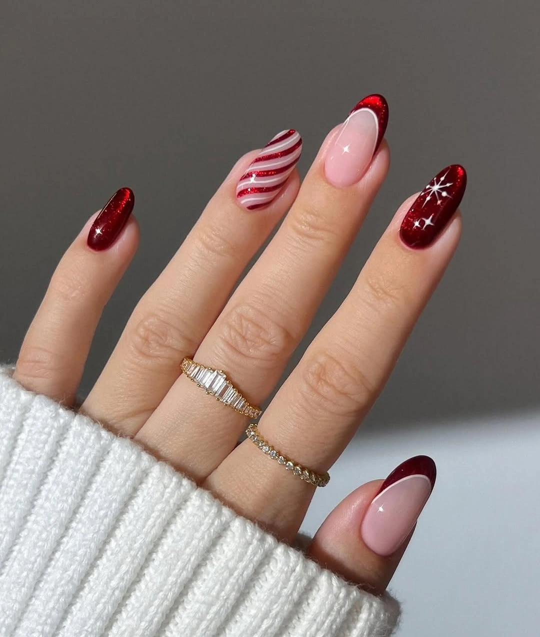 Almond burgundy red nails with stripes and star accents