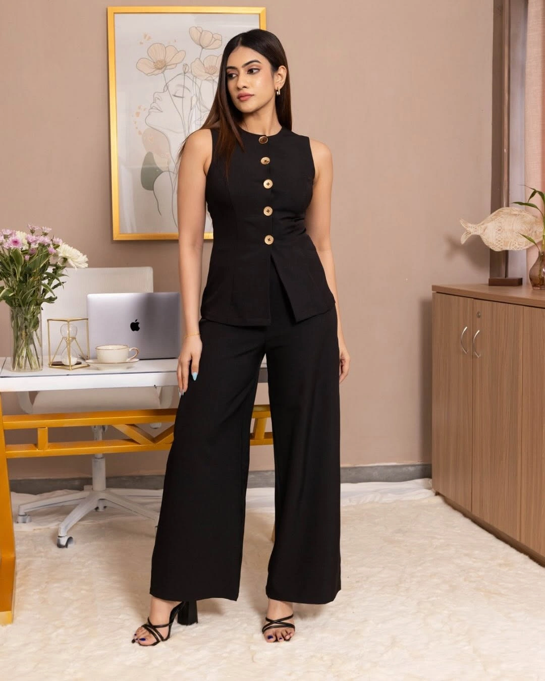 Black sleeveless buttoned top with matching cropped wide trousers