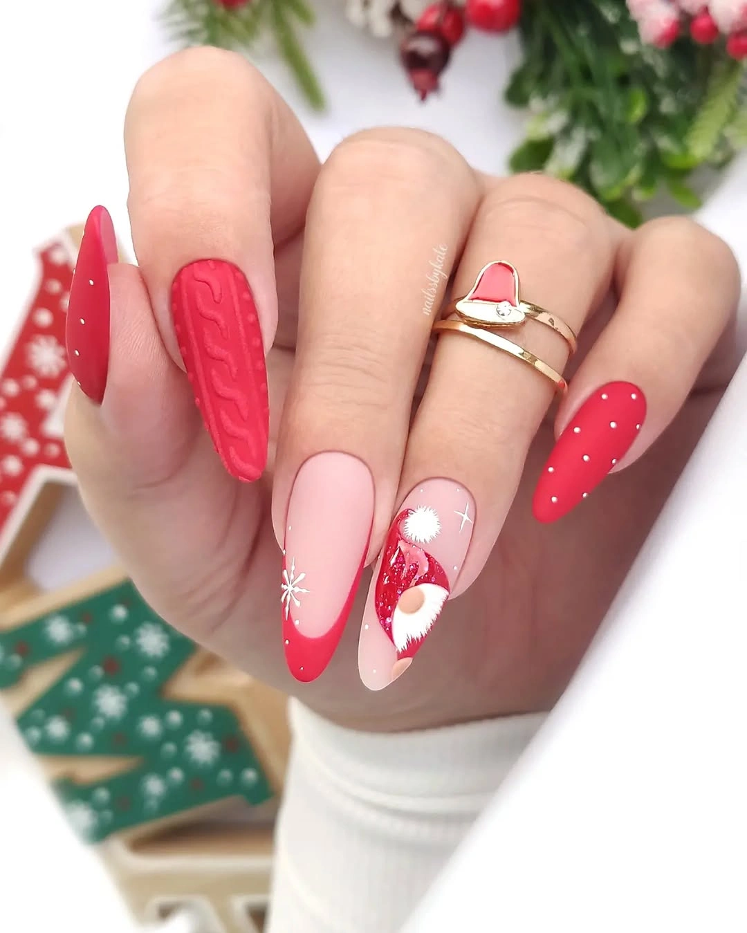 Red and pink almond nails with dots and character art