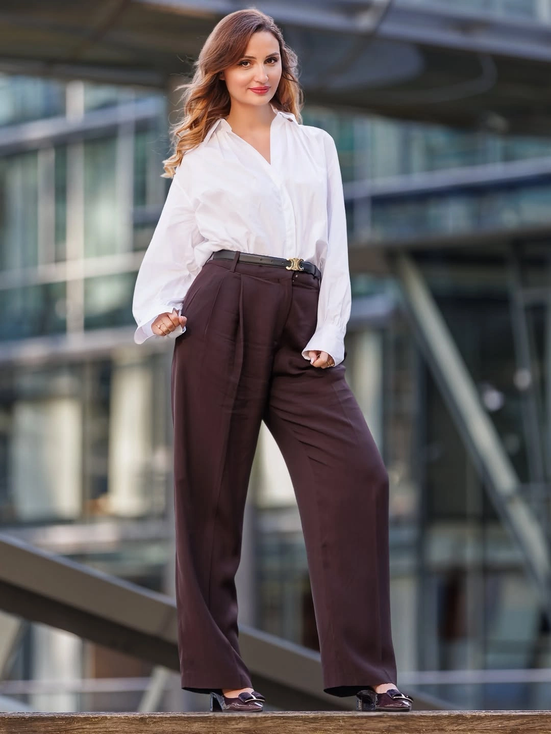White button-up shirt dark brown wide trousers and black belt