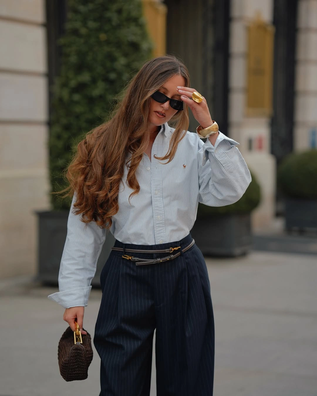 Light striped shirt with dark pinstriped trousers and brown bag