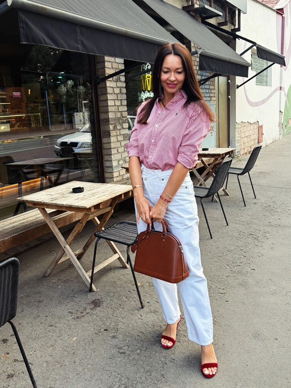 Pink striped shirt white trousers red heels and brown handbag