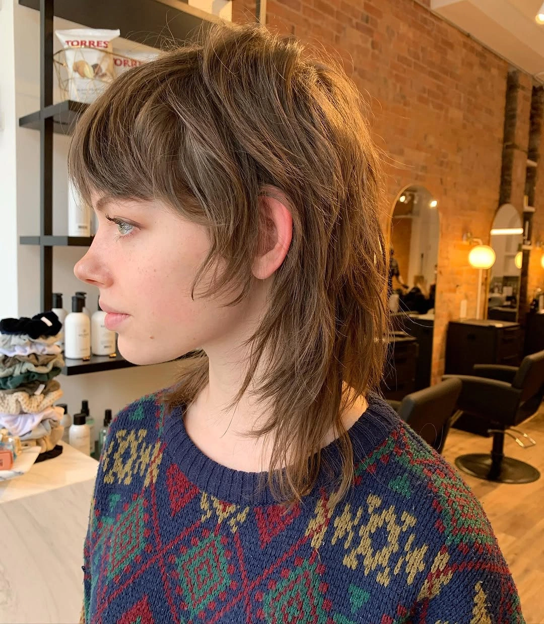 Brown shag-mullet with short crown layers and longer tapered nape