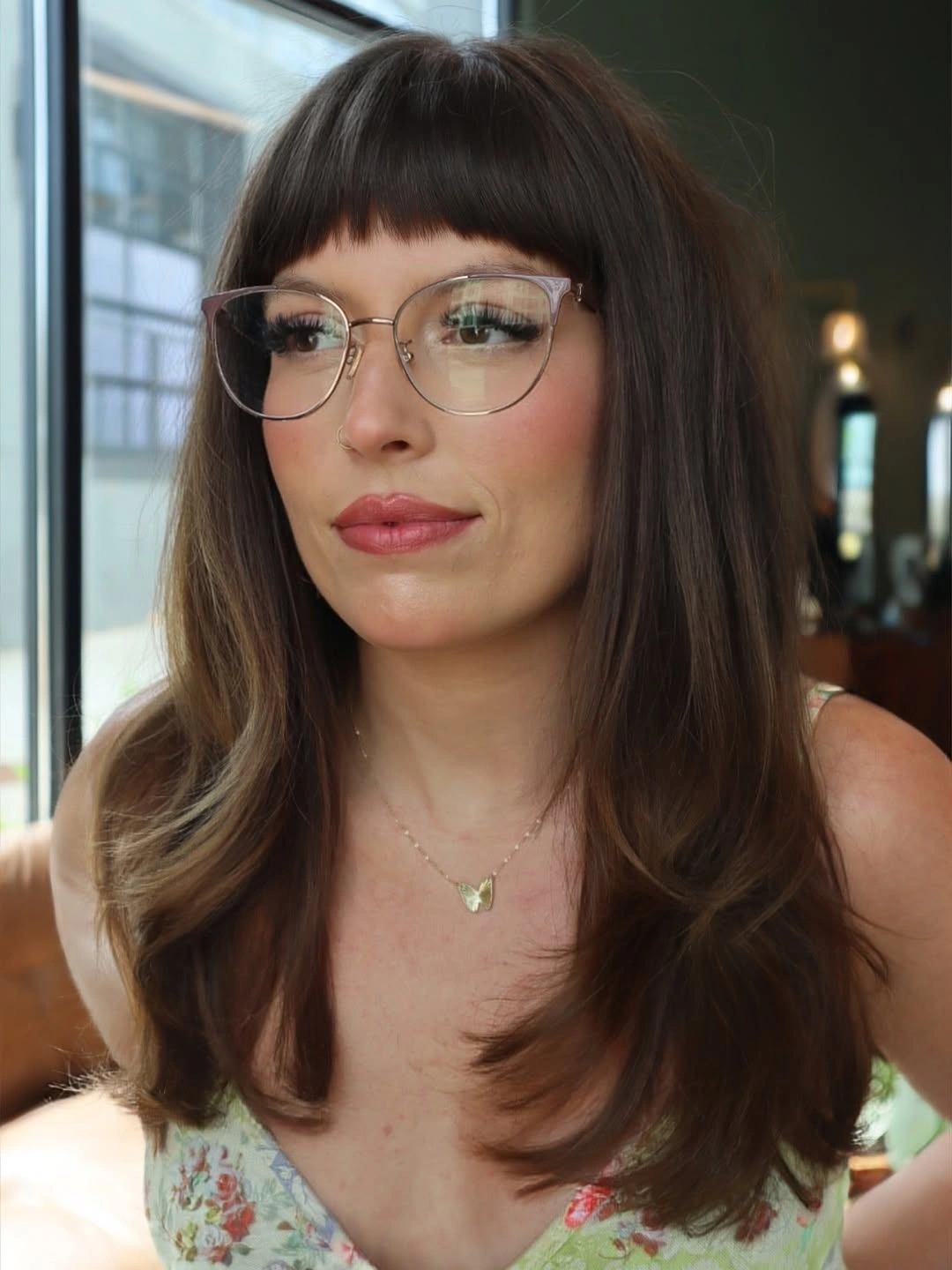Long dark brunette hair with straight bangs and softly curved ends