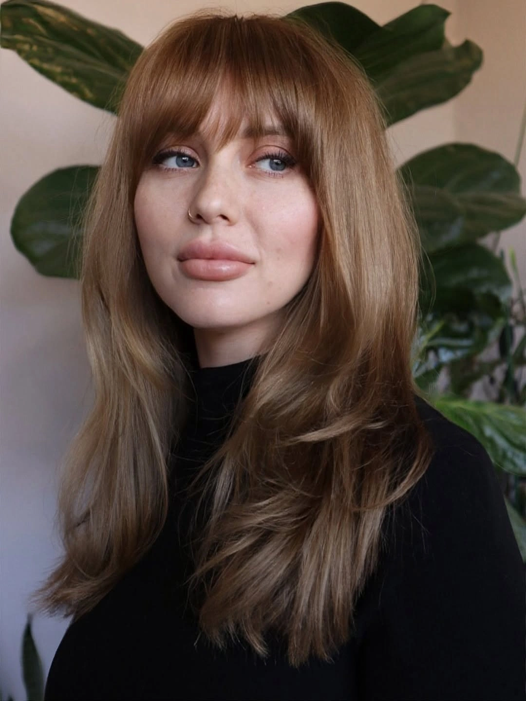 Long warm-brown hair with split fringe and sweeping face layers