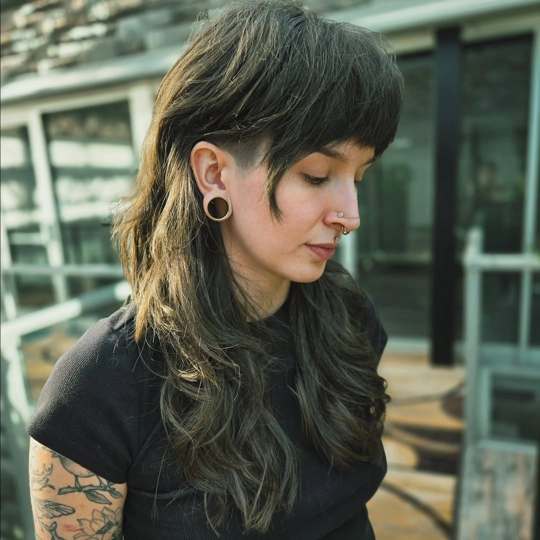 Long dark shag with short fringe and extended wavy layers