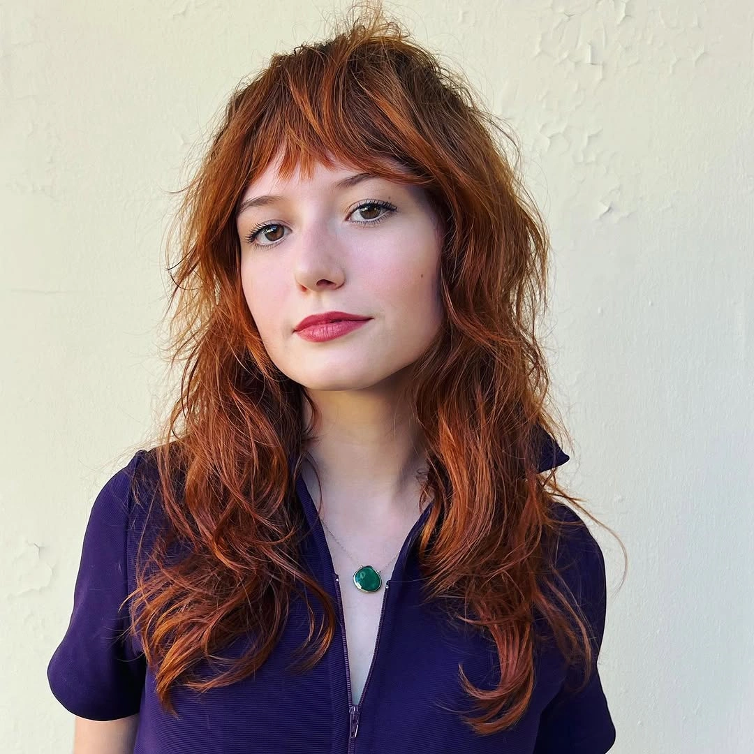 Copper layered shag with short wispy bangs and loose waves
