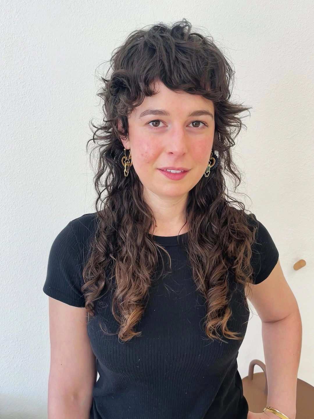 Long dark curly shag with rounded fringe and layered ringlets