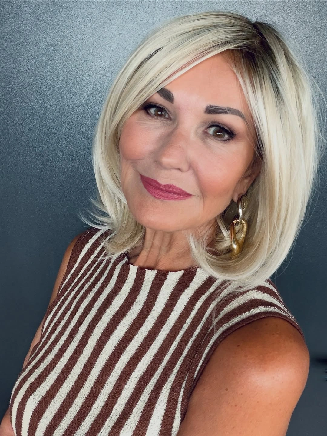 Pale blonde bob with deep side part and curved ends