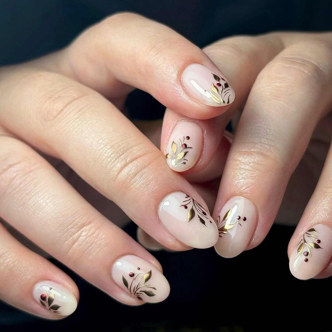 Short oval nails with black stems, gold leaves and burgundy dots