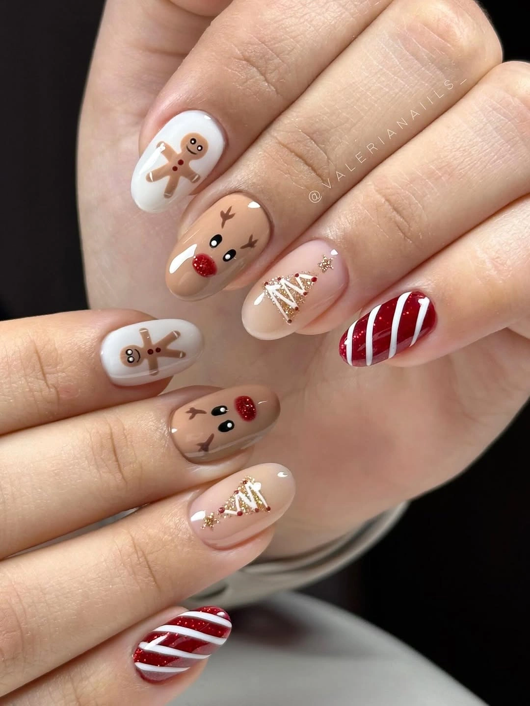 Almond nails with gingerbread reindeer and candy-cane stripes