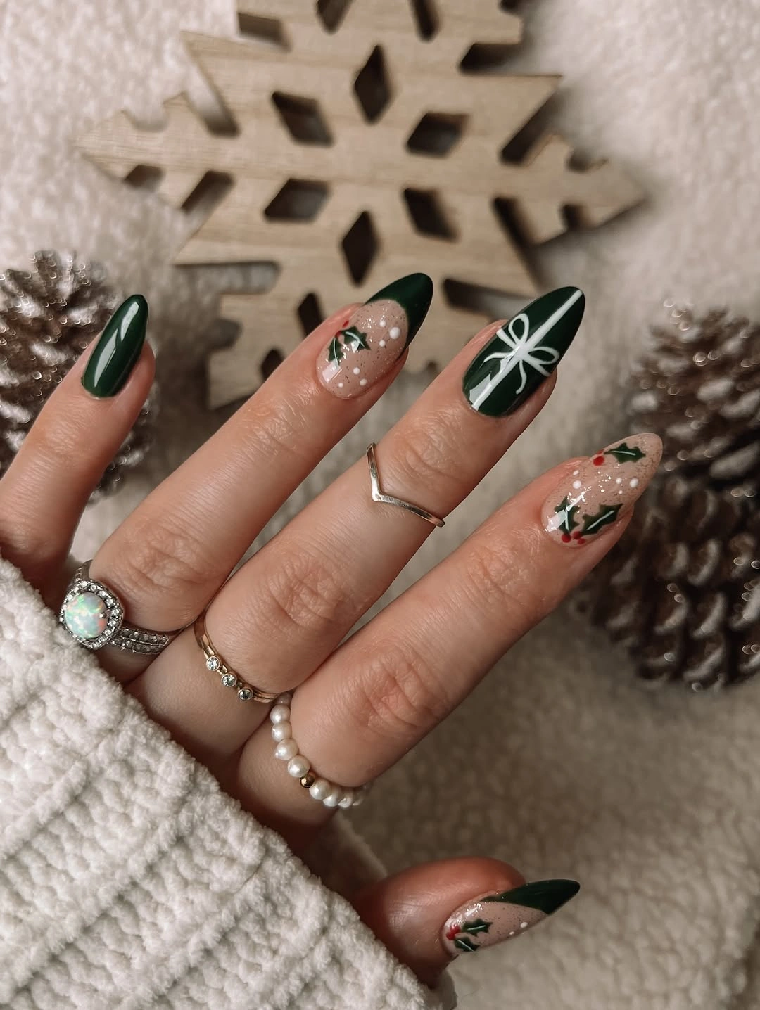 Deep green almond nails with holly and bow linework