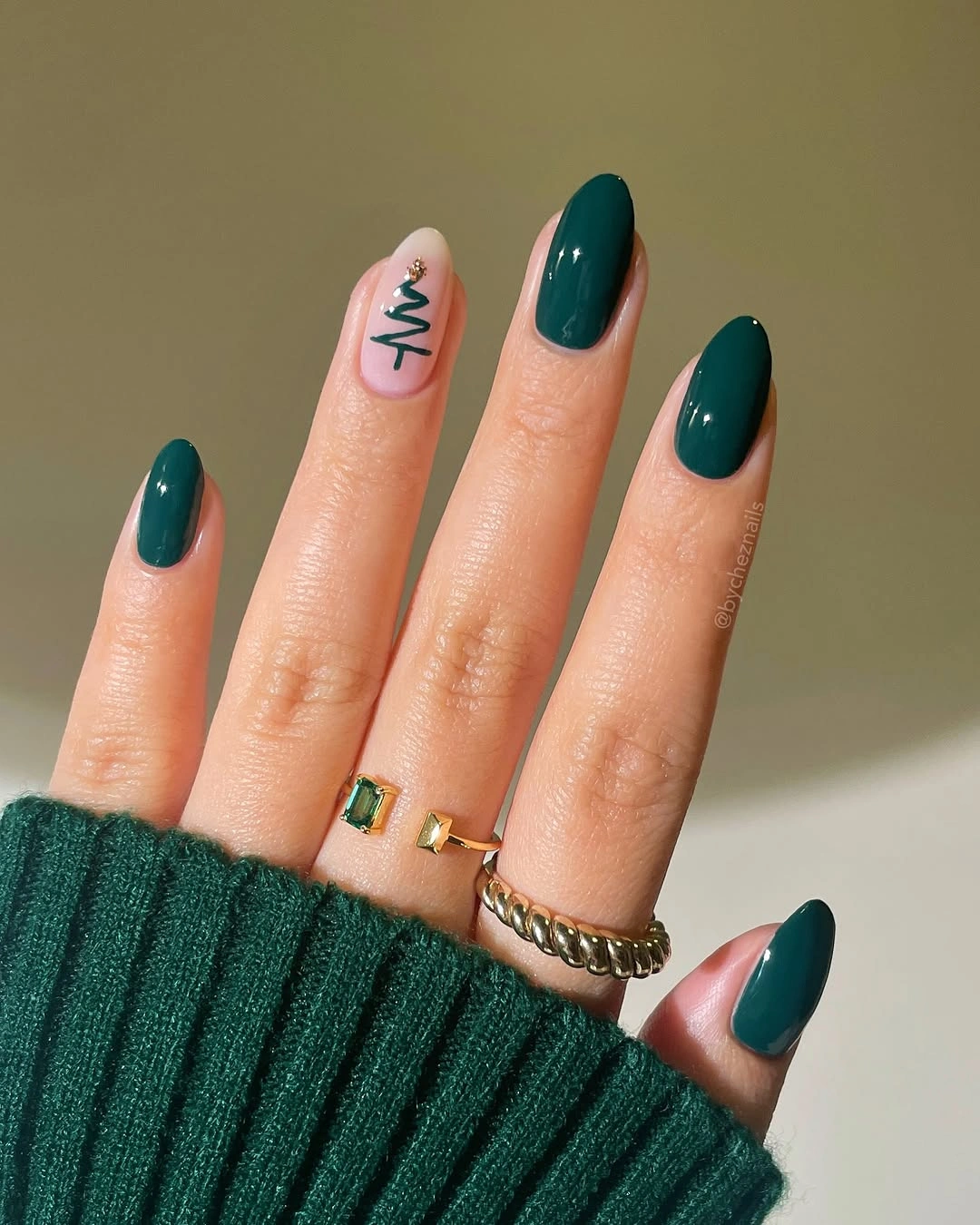 Glossy green almond nails with simple tree accent
