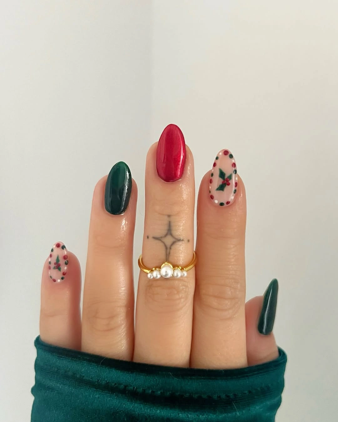 Red and green almond nails with dotted accent loops