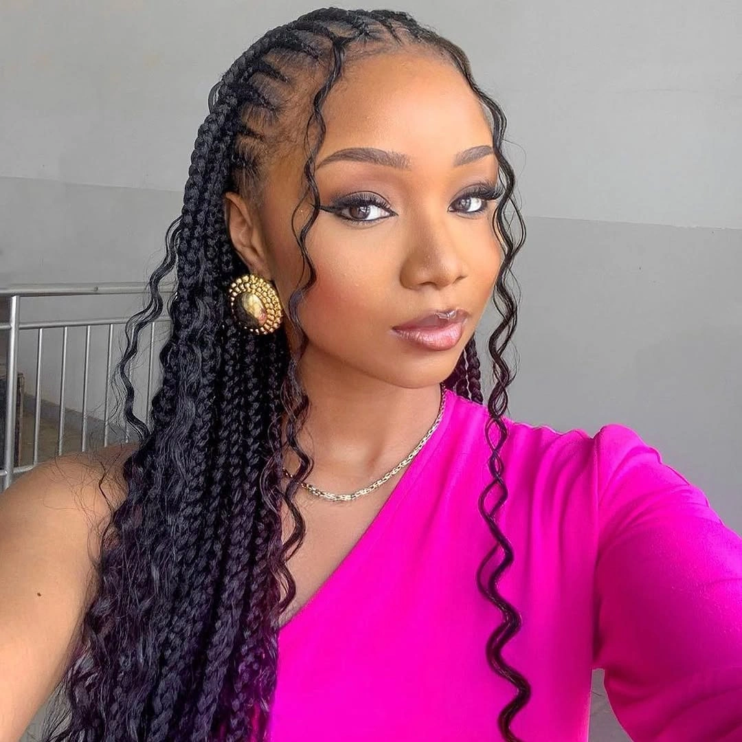 Side-swept braids with loose tendrils and pink top