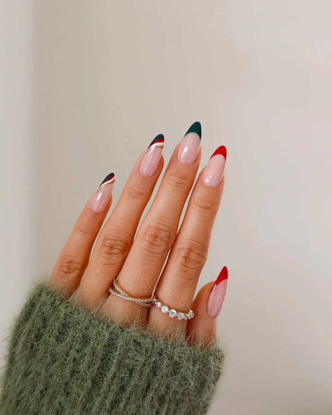 Almond nude nails with angled red and green tips