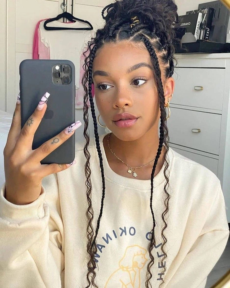 Braided high bun with long front braids and cream sweatshirt
