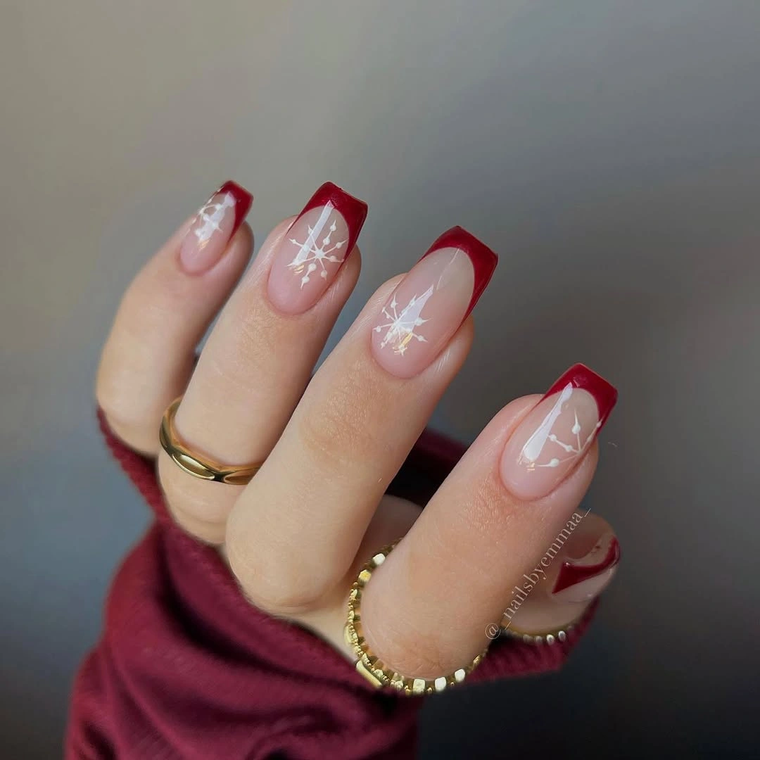 Long square nude nails with red tips and snowflakes