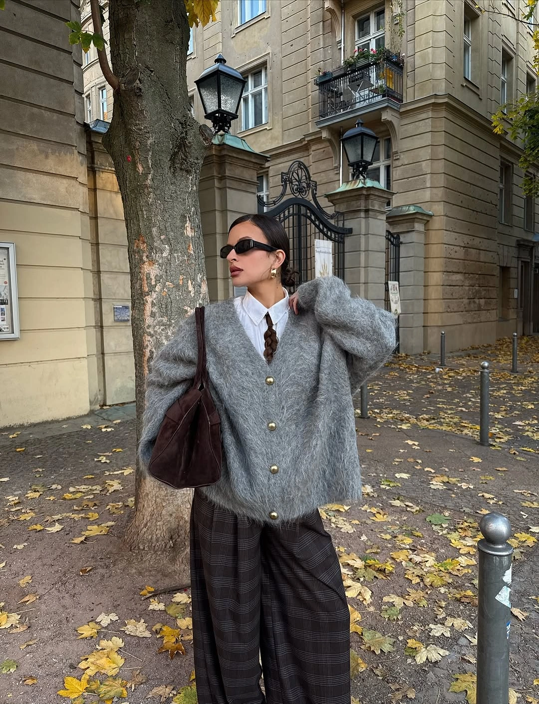 Shaggy gray buttoned layer with plaid trousers and burgundy bag