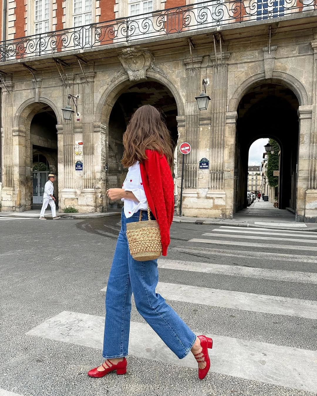 Red cardigan over white shirt with jeans and red shoes