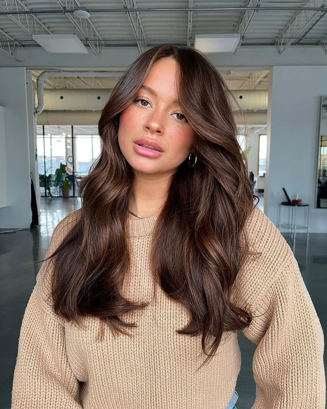 Long deep chocolate hair with soft face-framing layers