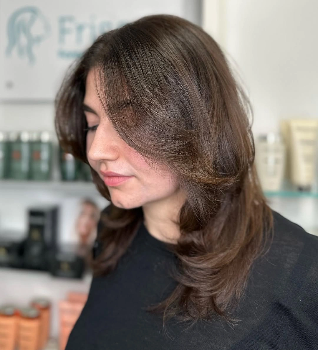 Medium-length mocha-brown hair with soft face-framing layers