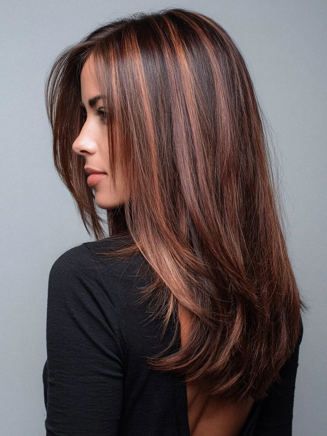 Long straight dark brown hair with copper-red ribbons