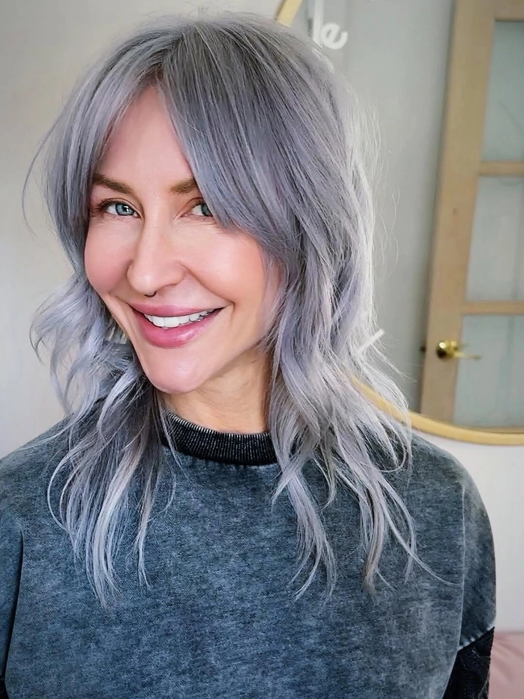 Cool gray medium-length layers with curtain bangs and waves